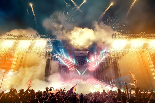 Crowd at concert and blurred stage lights with fireworks